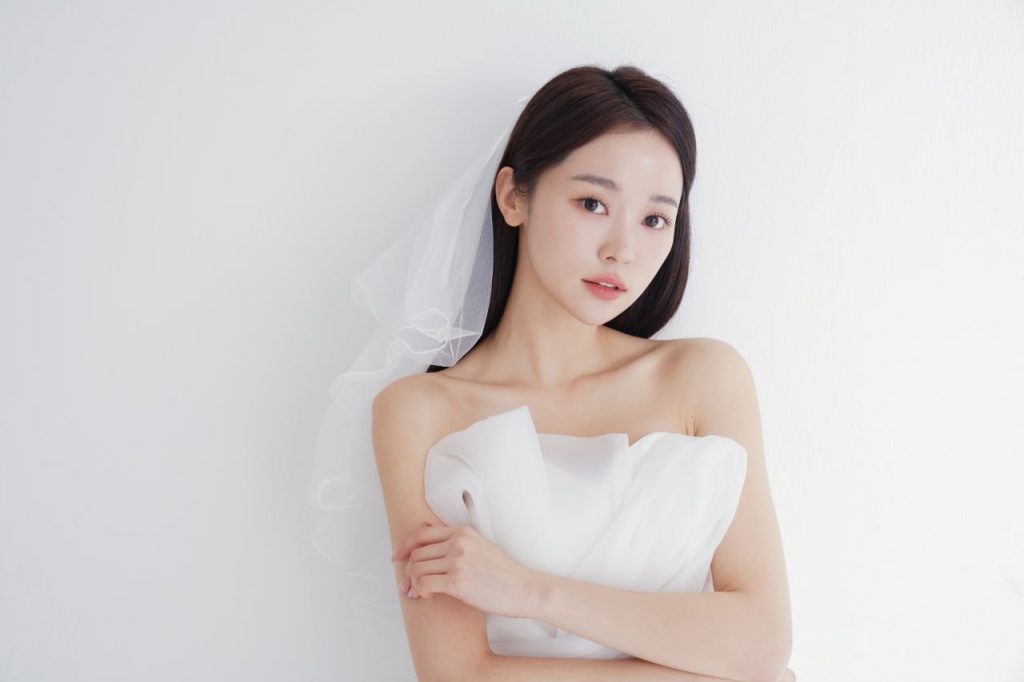 Bride in a white strapless gown and veil showing smooth, radiant skin for special occasion skincare promotion