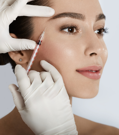 Patient receiving a Botox injection at the temple from a gloved practitioner in a clinical aesthetic setting
