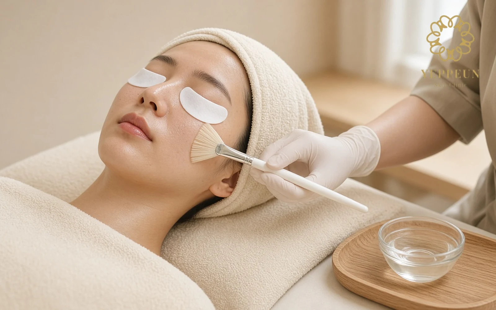 Woman having LHALA Peel solution brushed onto her cheek at Yeppeun Skin Clinic Dubai
